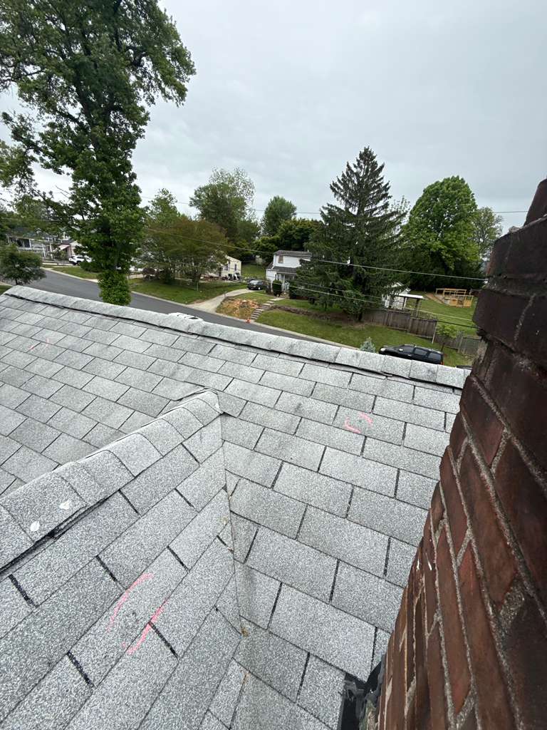 Roofer installing shingles